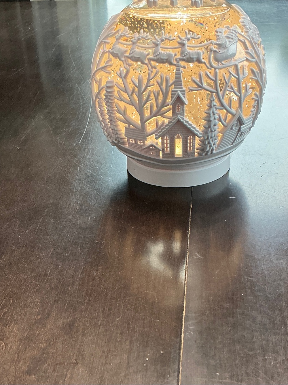 White snow globe that lights up and has a timer